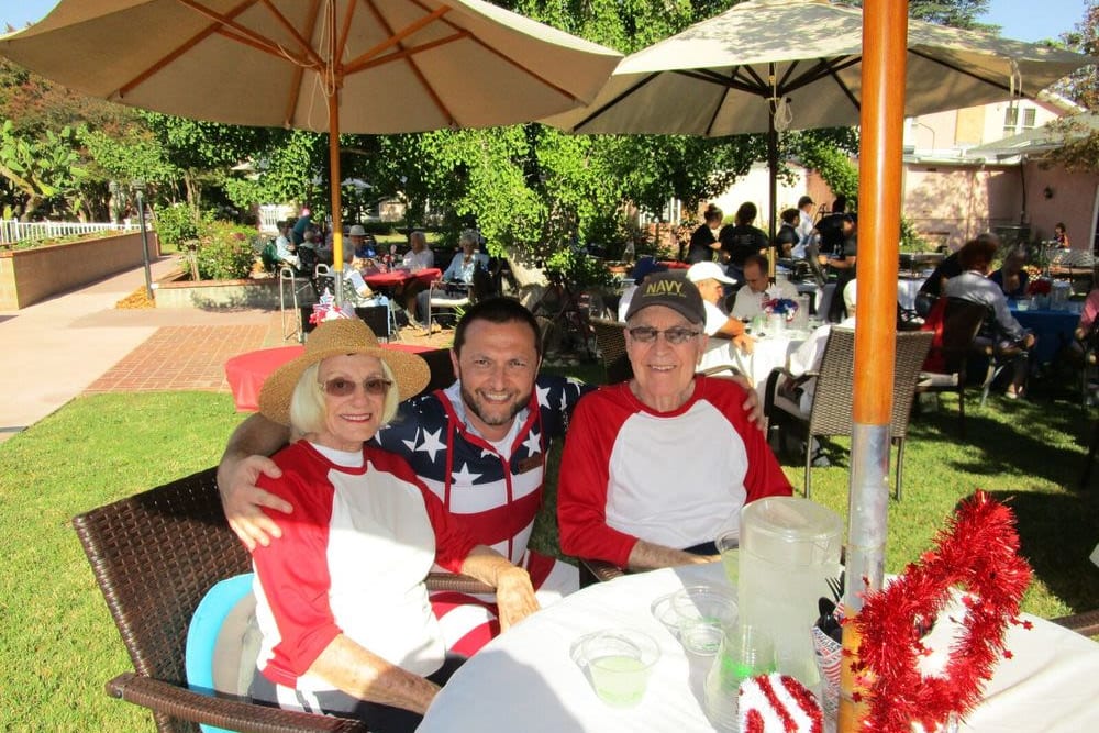 Two residents and a caretaker outside for the Independence Day barbecue at Gables of Ojai in Ojai, California 