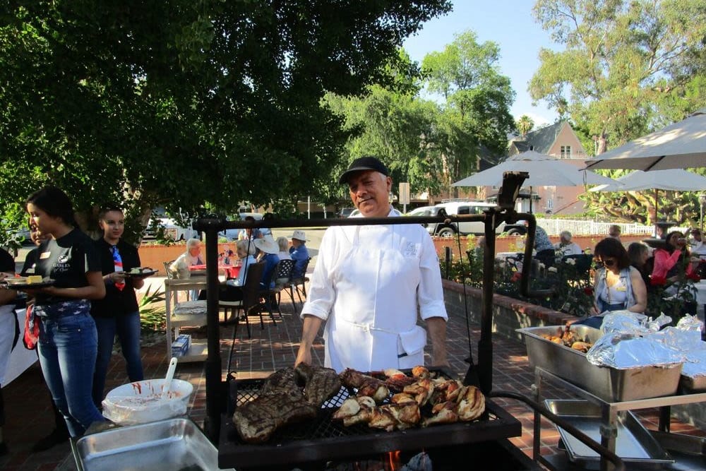 A chef grilling meat outside for residents at Gables of Ojai in Ojai, California