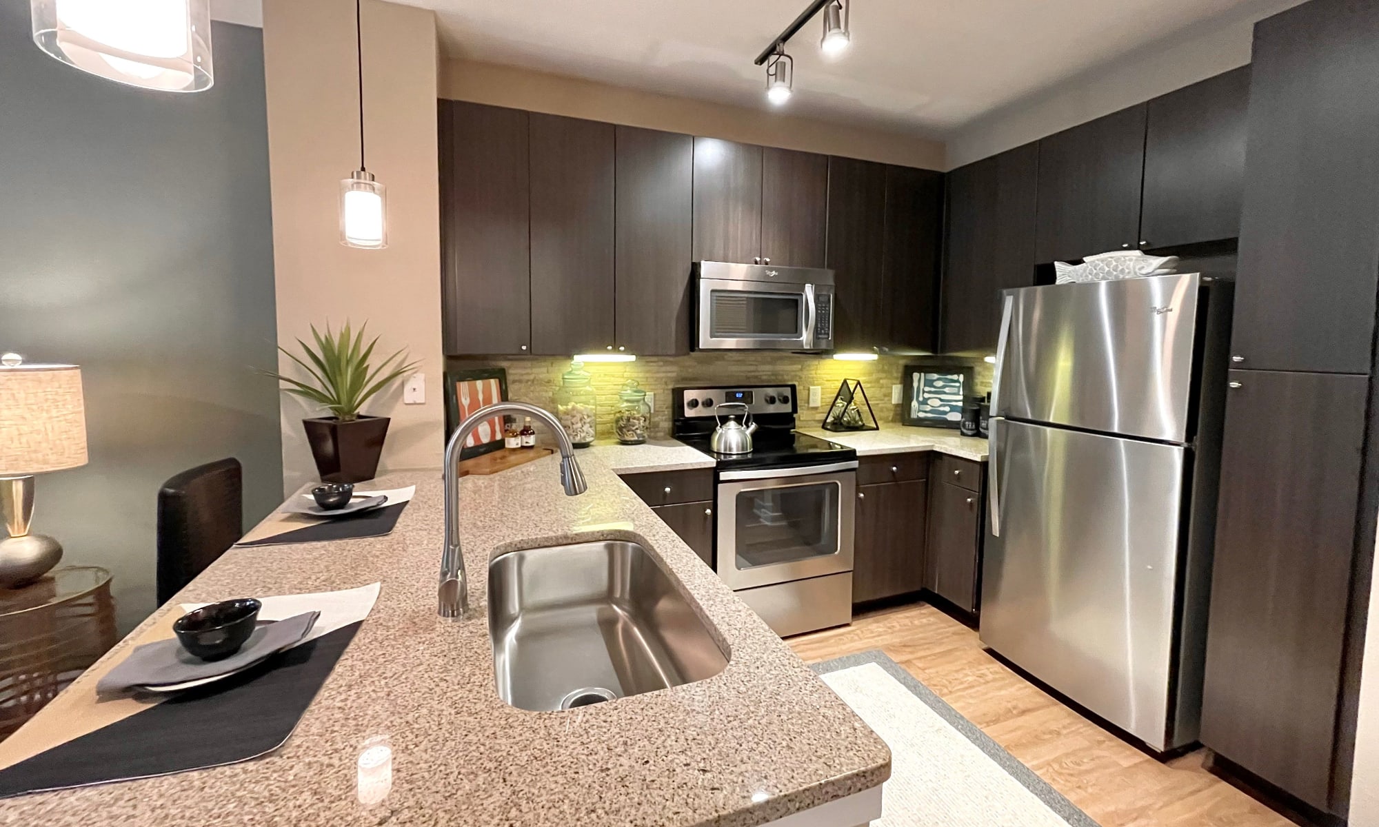 Kitchen with modern appliances at The Abbey at Spring Town Center in Spring, Texas