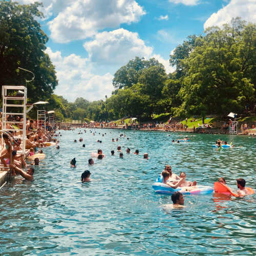 A group of residents swimming in a pool at Calder in Round Rock, Texas