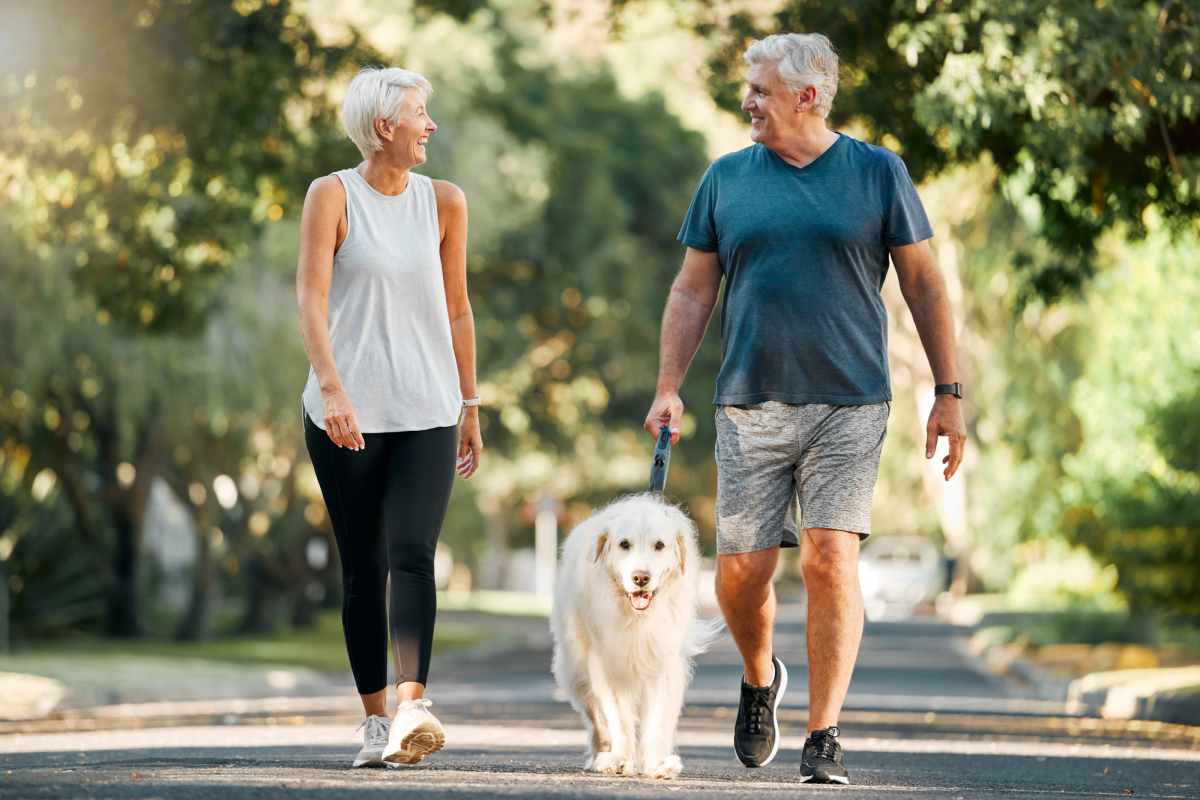 Residents walking in park with their dog at Villas At Mount Zion in Stockbridge, Georgia 