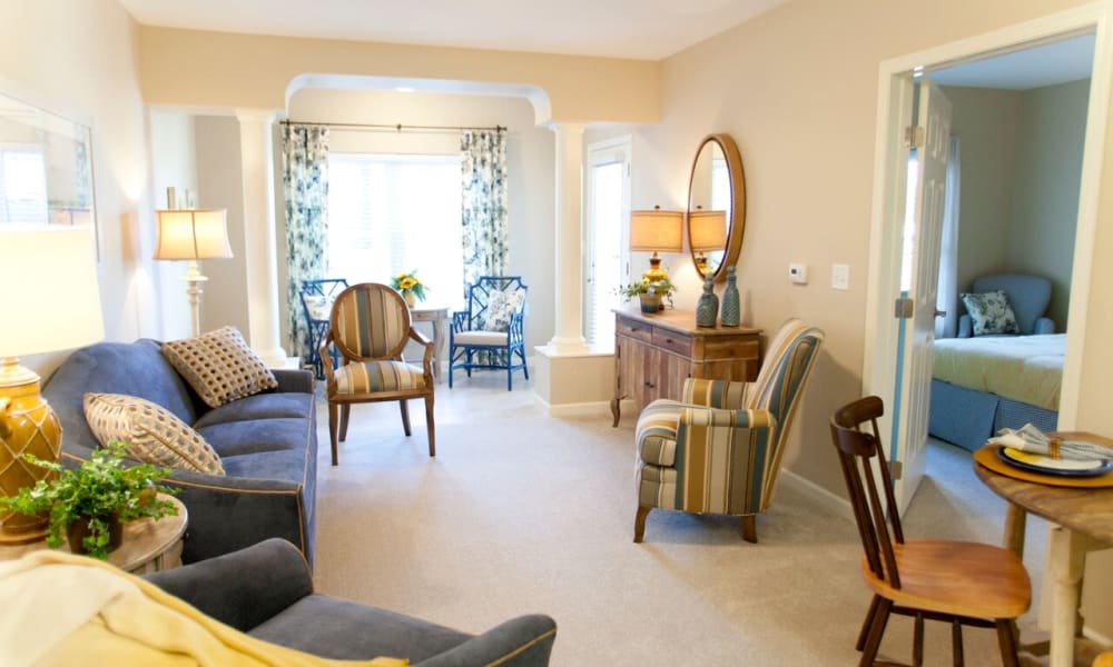 An apartment living room and bedroom at Keystone Place at LaValle Fields in Hugo, Minnesota