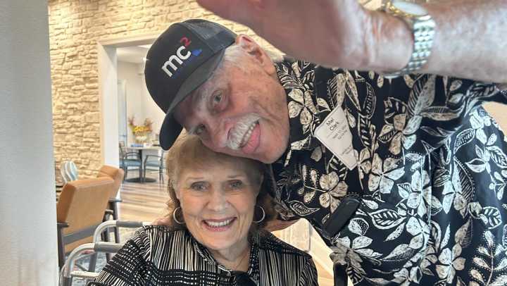 A smiling couple shares a joyful moment at The Landing at Woodland Lakes in Conroe, Texas, enjoying time together in assisted living.