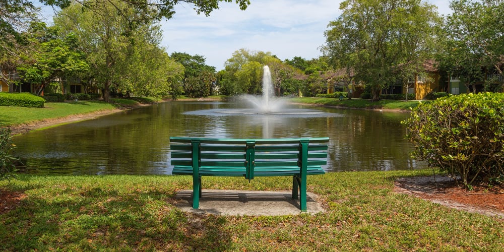 Bench in front of the pond and fountain at Indian Hills Apartments in Boynton Beach, Florida