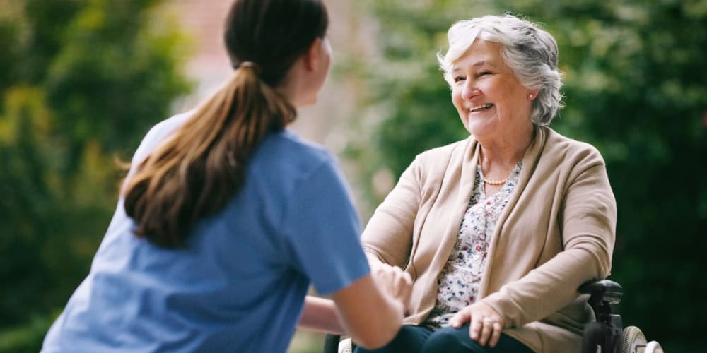 A staff member helping a resident at Truewood by Merrill, New Bern in New Bern, North Carolina. 