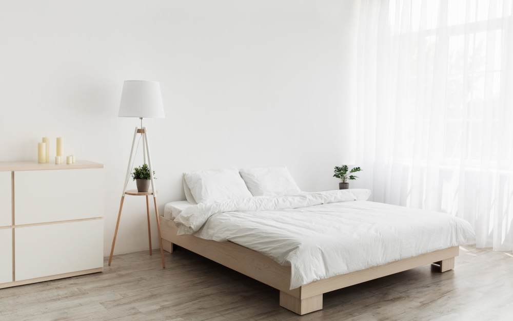 Model bedroom with lamp and large window and  at The Morgan in Bedford, Texas