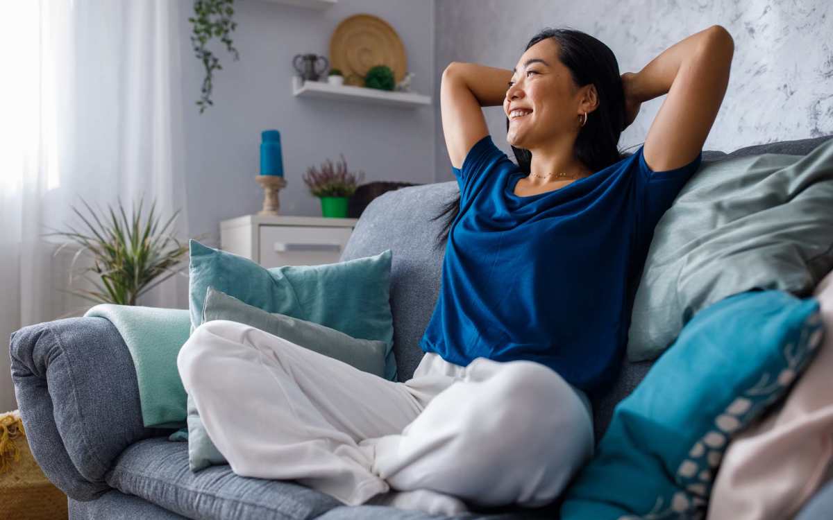 Resident relaxing in living room at Ivey Ridge Apartments in Graham, North Carolina