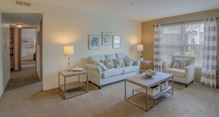 Spacious living room with large windows and natural lighting at Gateway Lakes Apartments in Grove City, Ohio