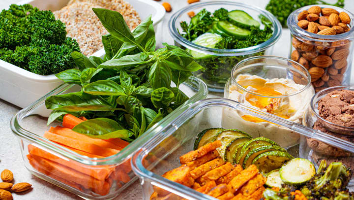 Containers of nuts, vegetables, and desserts on a table | meal prep services in San Diego