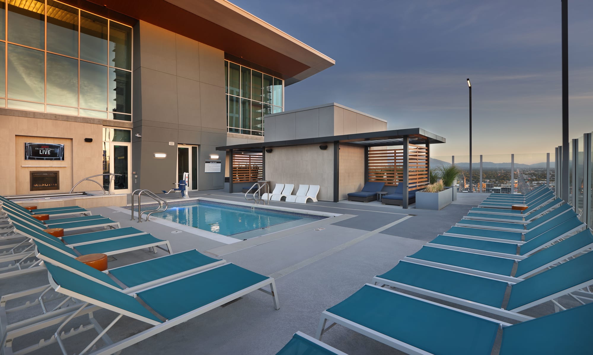 21st floor pool at sunset surrounded by teal lounge chairs at Luxury high-rise community of Liberty SKY in Salt Lake City, Utah