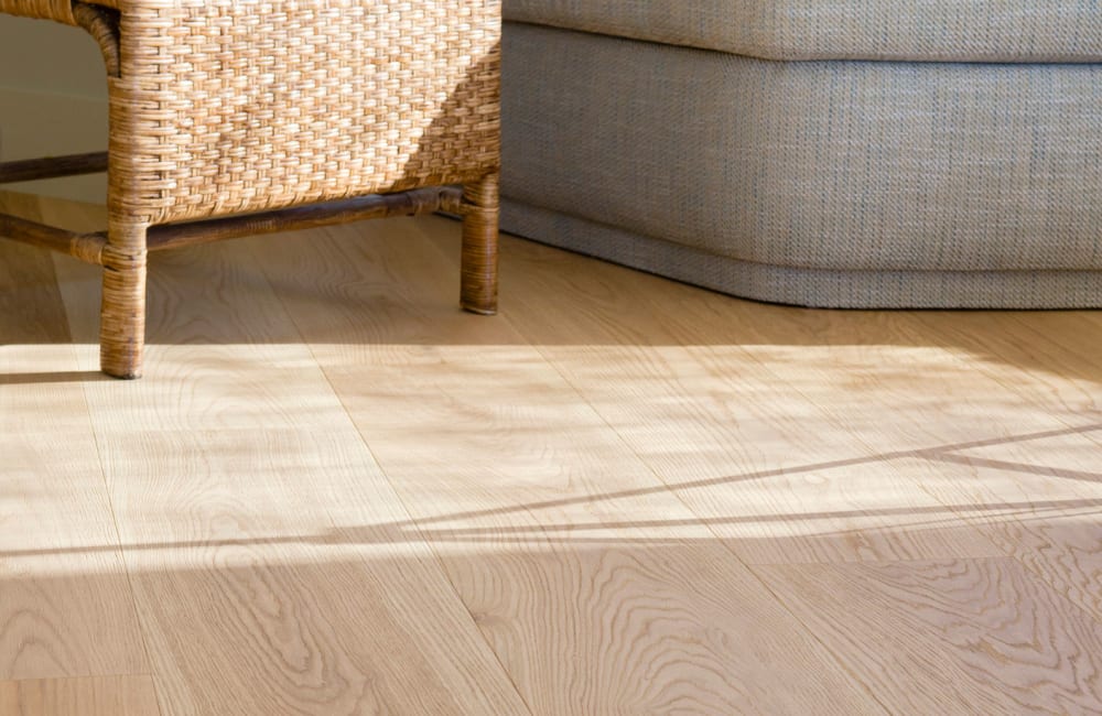 Beautifully finished hardwood flooring in a model apartment's living area at Verano in Perris, California