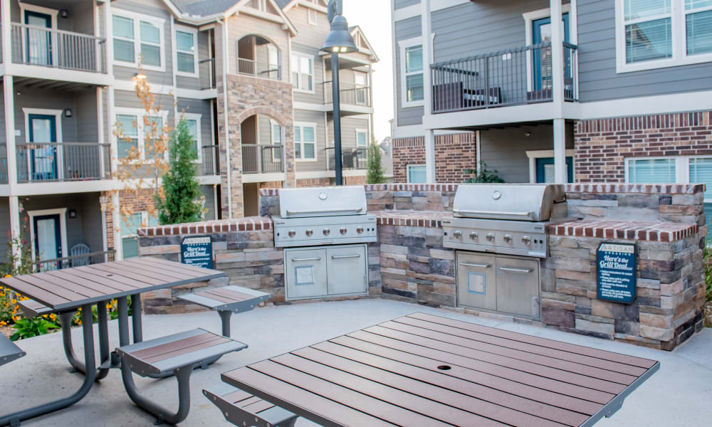 Grilling area next to pool with tables to use at Artisan Crossing in Norman, Oklahoma