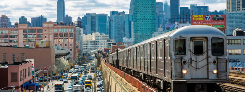 Cool photo of the train passing by the busy streets near Eastgold NYC in New York, New York