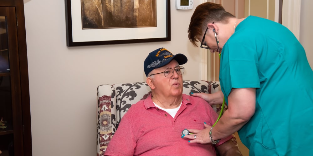 A nurse checking the breath of a patient at Careage Home Health in Bellevue, Washington. 