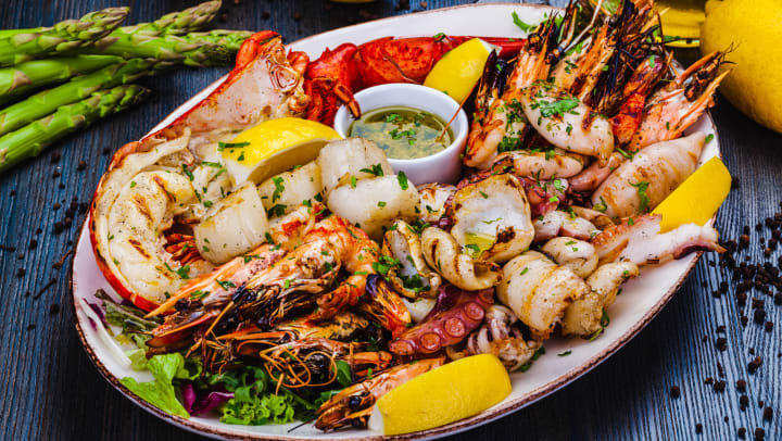A plate of seafood with lobster, shrimp, and scallops from a restaurant in Spring.
