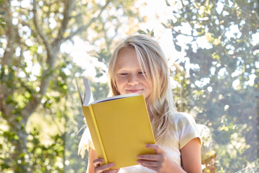 Resident student reading a book in her new home at Sofi Dublin in Dublin, California