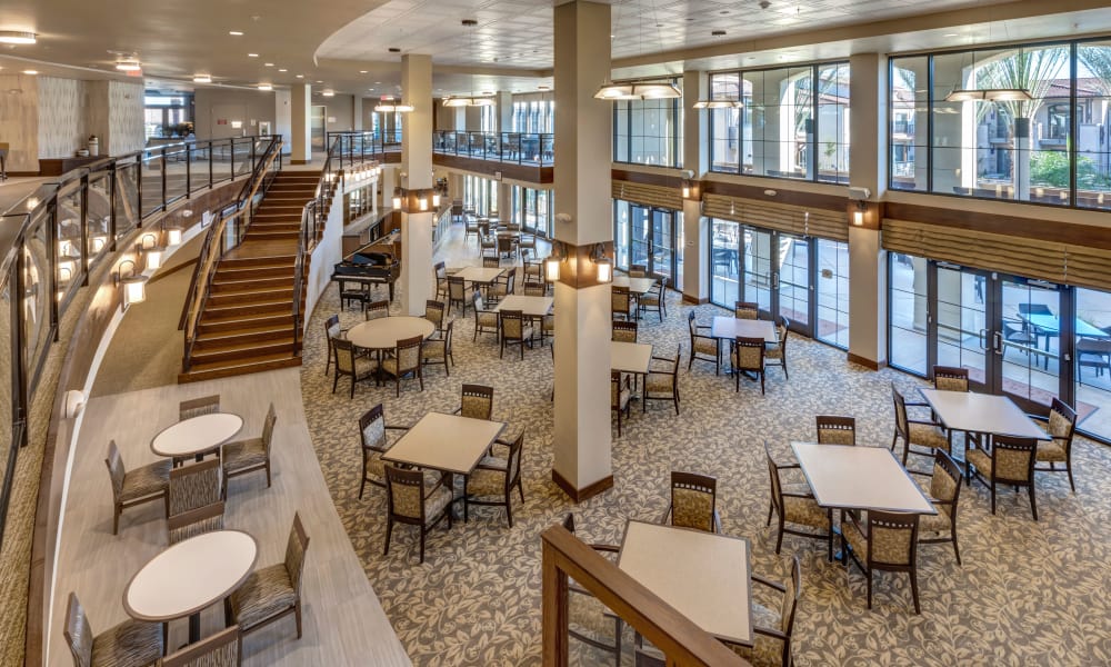 Dining area with large windows and open space at Merrill Gardens at Rancho Cucamonga in Rancho Cucamonga, California. 