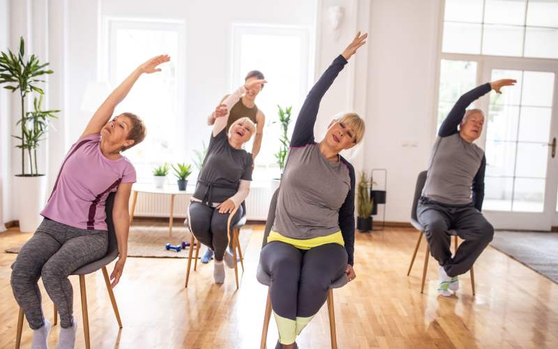 Residents participating in yoga at Grand Villa of Ocala in Ocala, Florida