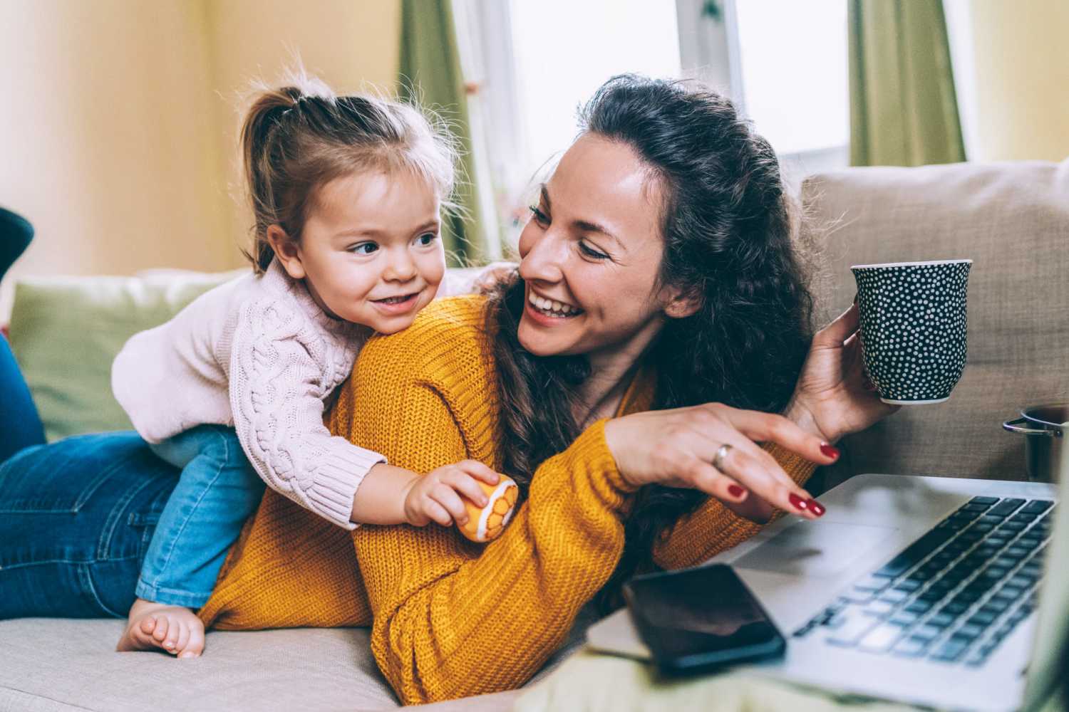 Resident woman with her daughter, using the online payments portal at West Unity Villas in West Unity, Ohio