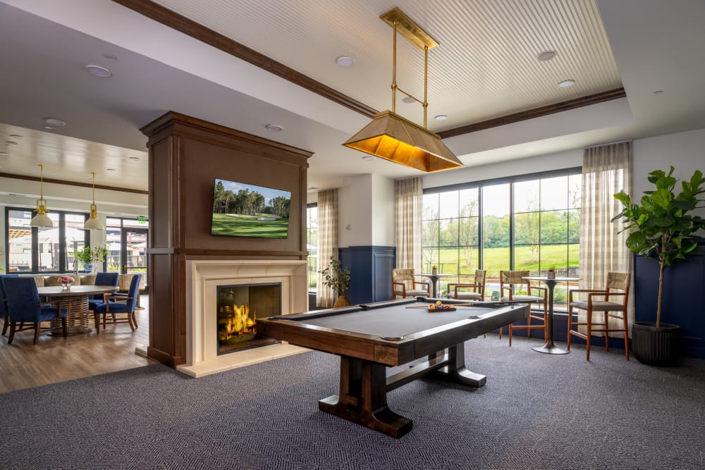 Club room with pool table and fireplace at an Amira community