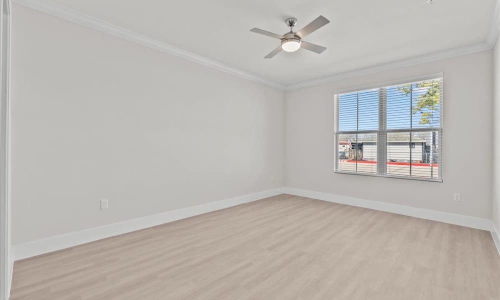 Bedroom with ceiling fan and a window at Magnolia Living in League City, Texas