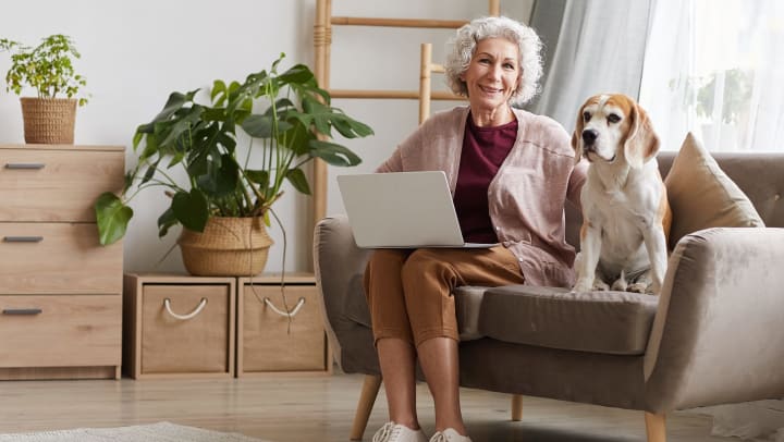 Senior woman with her dog on couch