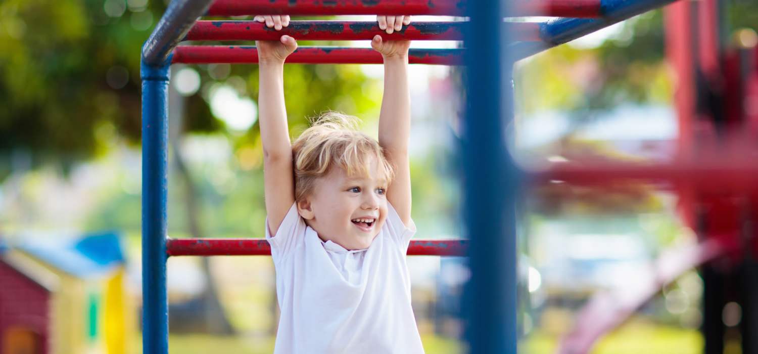 A kid playing in a playground at Brookhollow in Whitesboro, Texas