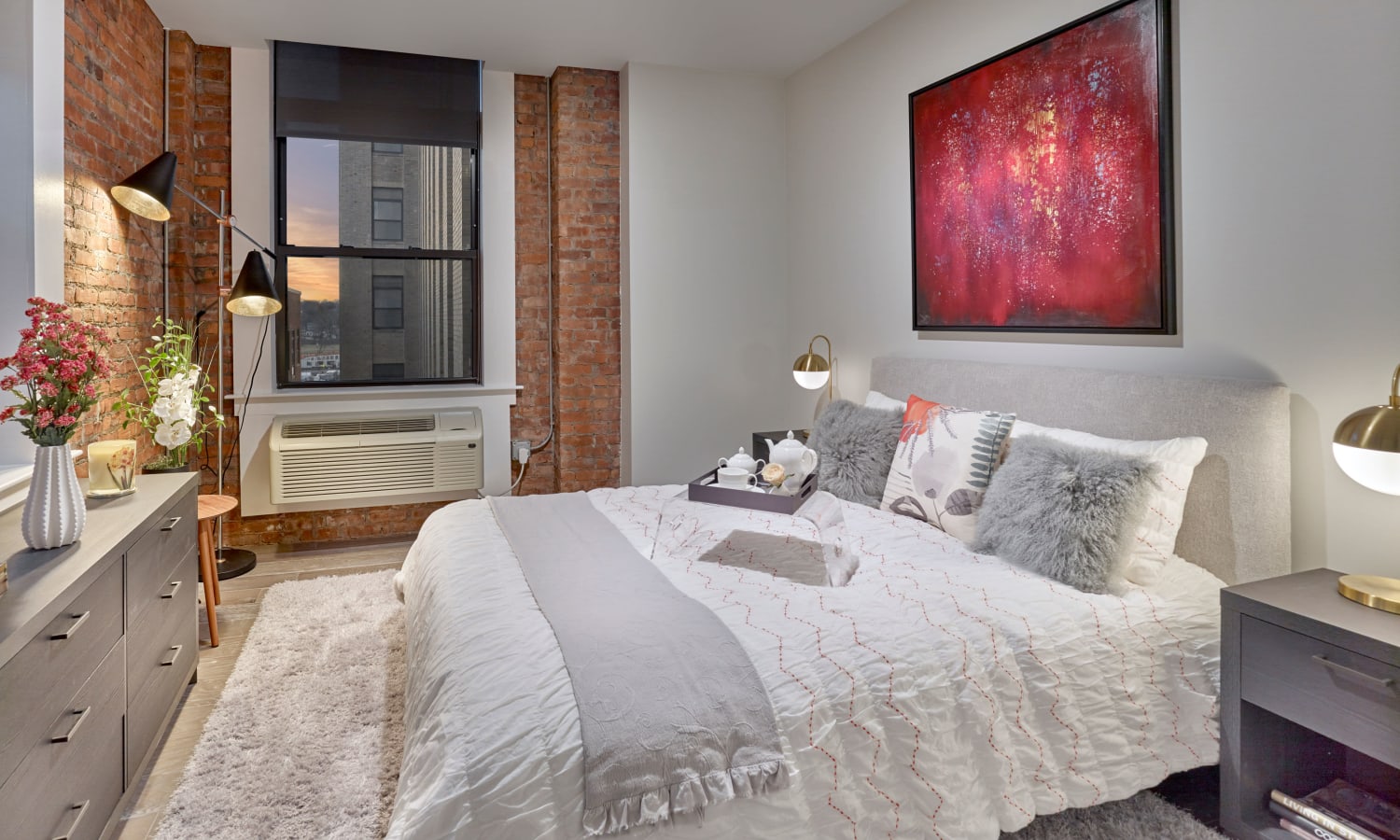 Model bedroom with exposed brick at 210 Main in Hackensack, New Jersey