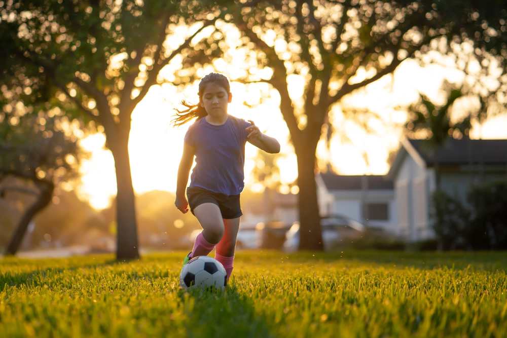Girl playing football at 275 Chestnut Supportive Housing in Springfield, Massachusetts