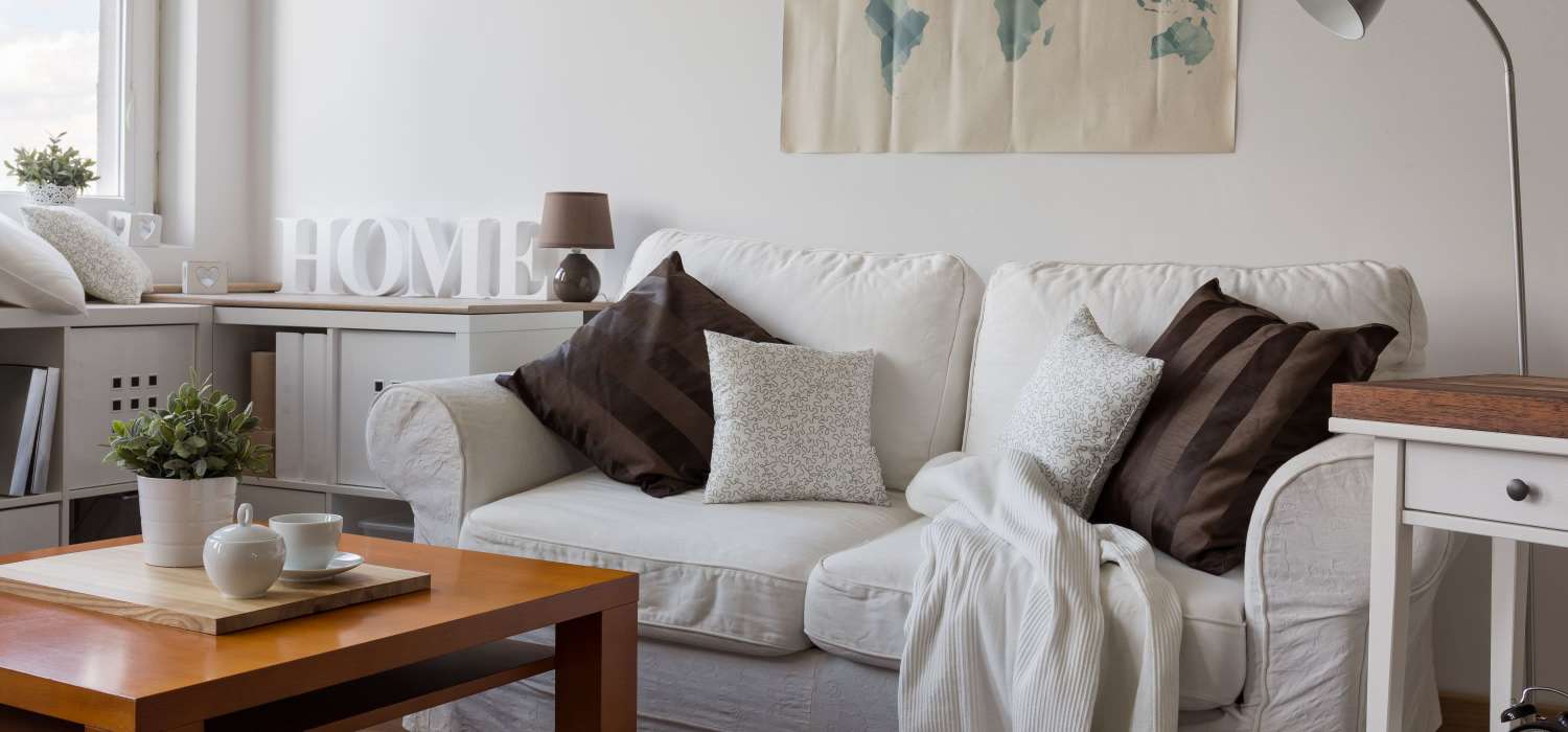 Living room with cozy sofa at Townsend Trace Apartments in Greensboro, North Carolina