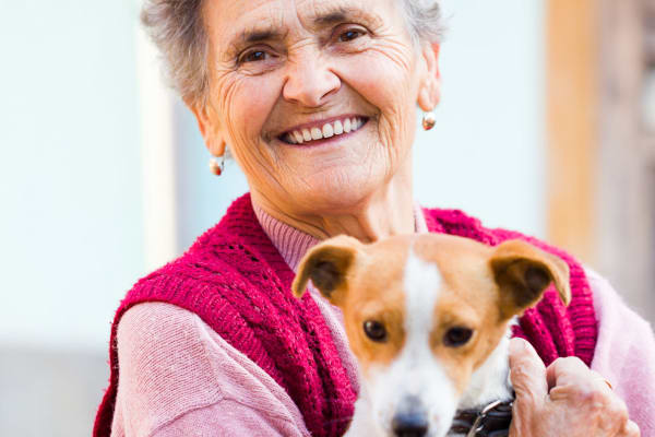 Resident holding her dog at Bayberry Commons in Springfield, Oregon