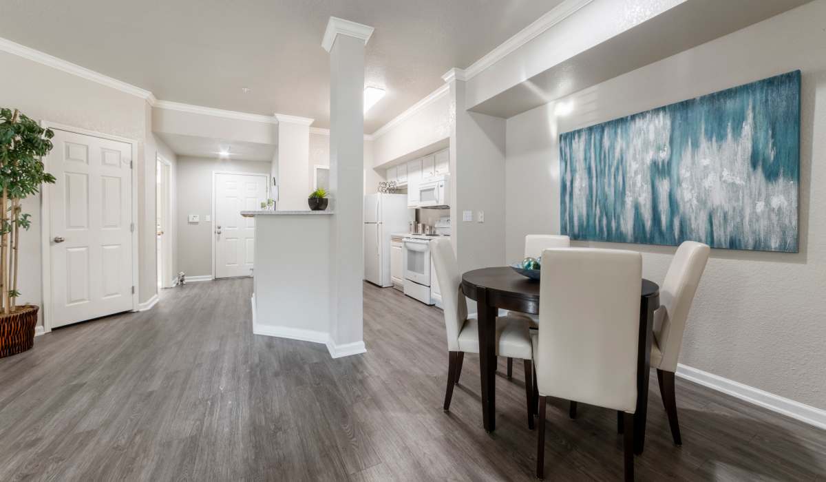 Dining and kitchen area with wood-style flooring at Oak Brook Apartments in Rancho Cordova, California