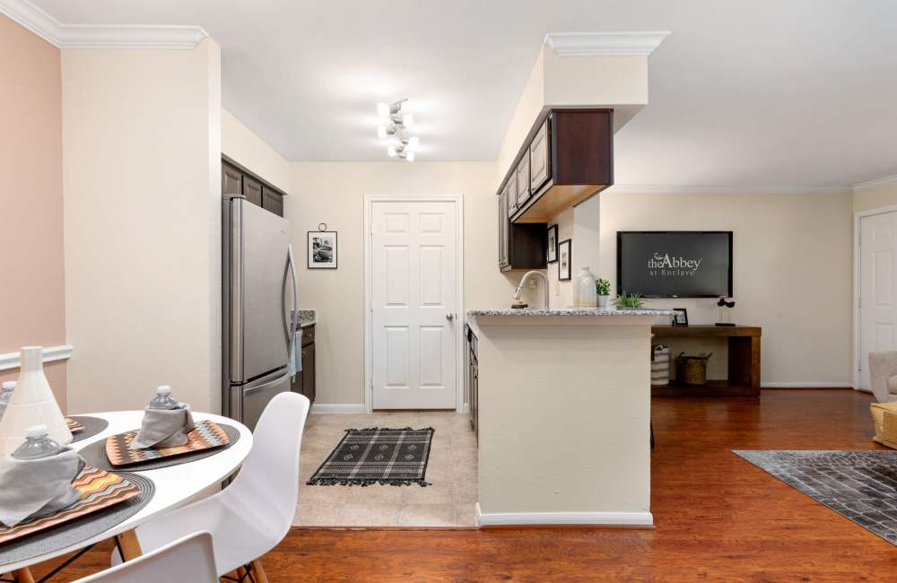 Modern kitchen with breakfast counter at The Abbey At Enclave in Houston, Texas