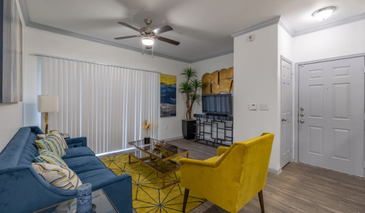 Living room with blue sofa and yellow chair at Legacy at Cypress in Cypress, Texas