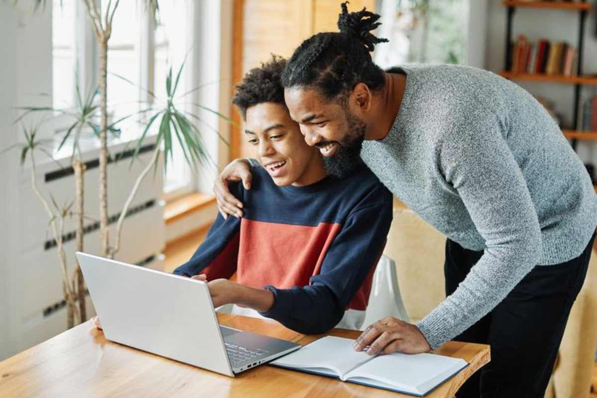  Resident helping his kid in studies at SETH I in Boston, Massachusetts