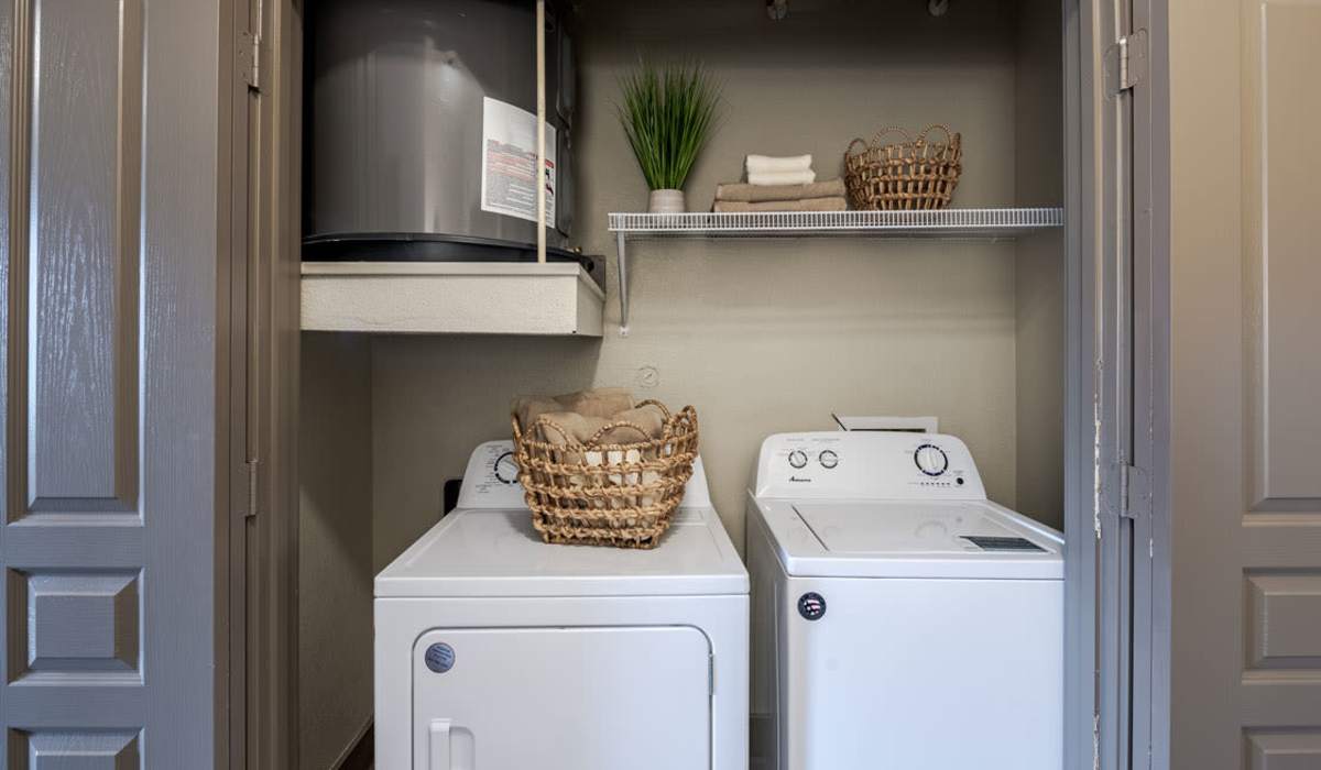 Laundry closet with washer and drier at Dayrise at Centreport in Fort Worth, Texas