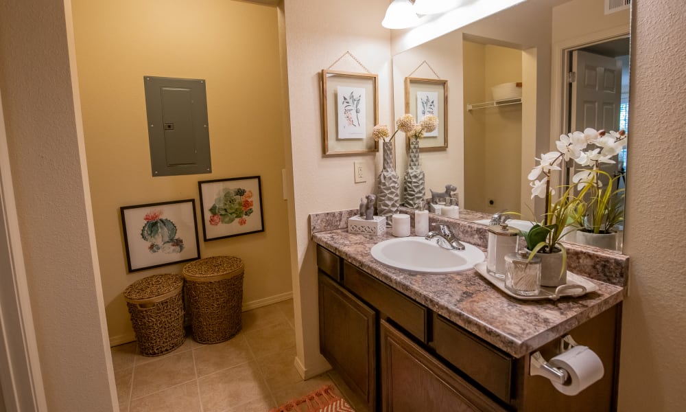 A comfy bathroom with laundry at Tuscany Hills in Tulsa, Oklahoma