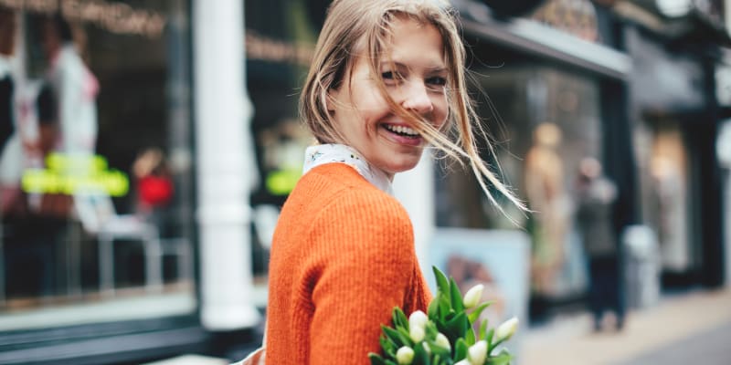 Resident walking with a bouquet near Hallfield Apartments in Nottingham, Maryland