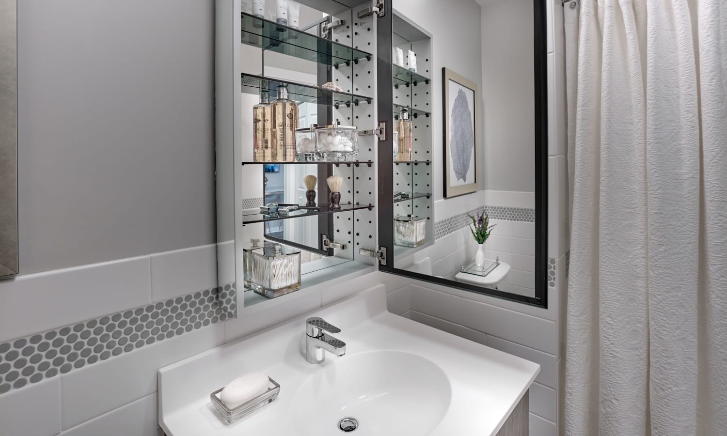 Model bathroom with mirror storage at 210 Main in Hackensack, New Jersey