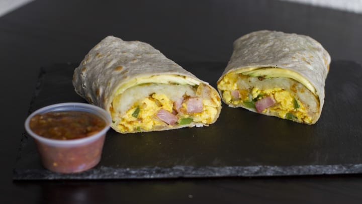 Breakfast burrito with cup of salsa