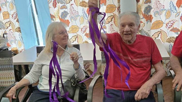 Residents participating in a ribbon exercise activity at The Landing at Stone Oak in San Antonio, TX, promoting movement and engagement.
