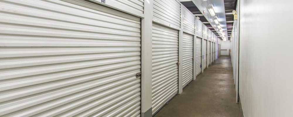 A well-lit hallway of indoor storage units at Nova Storage in Lancaster, California