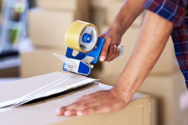 Man taping a box shut at Midgard Self Storage in Cashiers, North Carolina