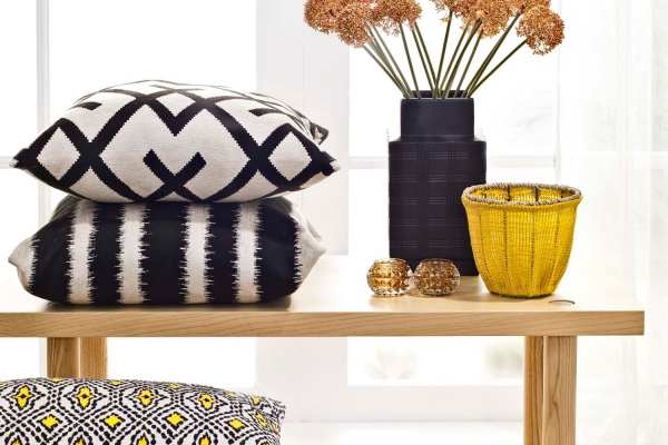 Retro-modern furniture and classic decor in a model home's living area at Victoria Pointe Apartments in Jackson, Michigan