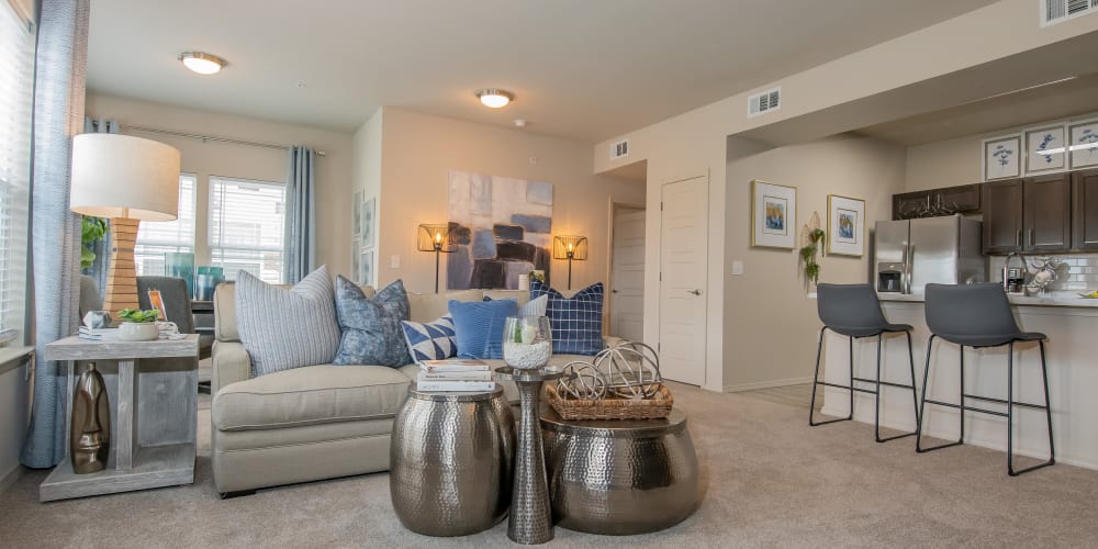 Stunning living room with plush carpet at Bend at New Road Apartments in Waco, Texas