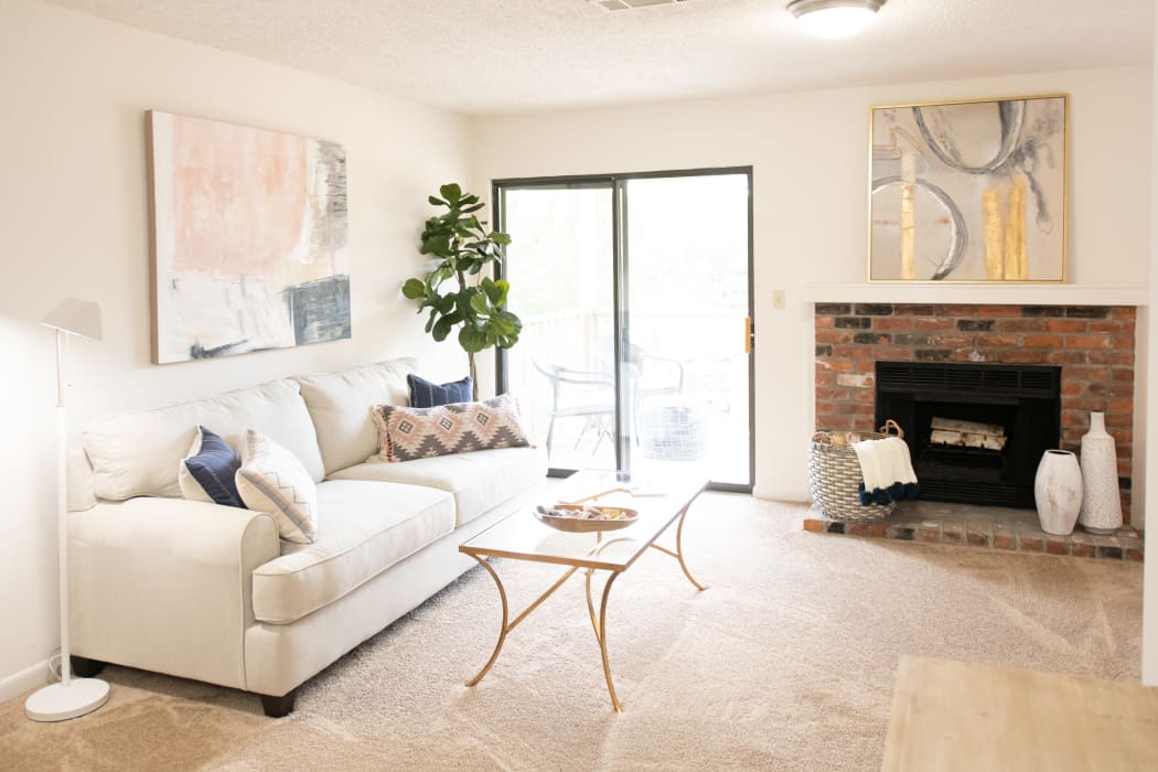 Living room with fireplace at The Mark Apartments in Ridgeland, Mississippi