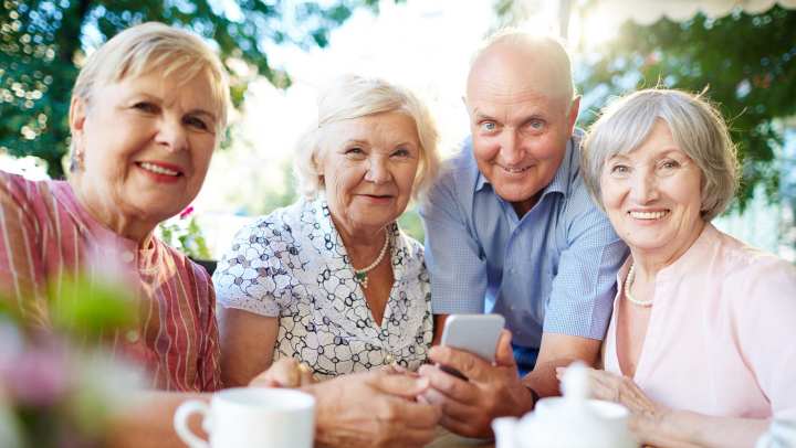 Four senior people taking a picture