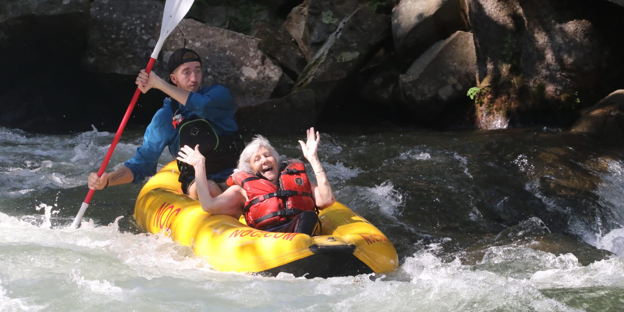 A happy resident from Bella Vista Gracious Retirement Living in Asheville, North Carolina, whitewater rafting
