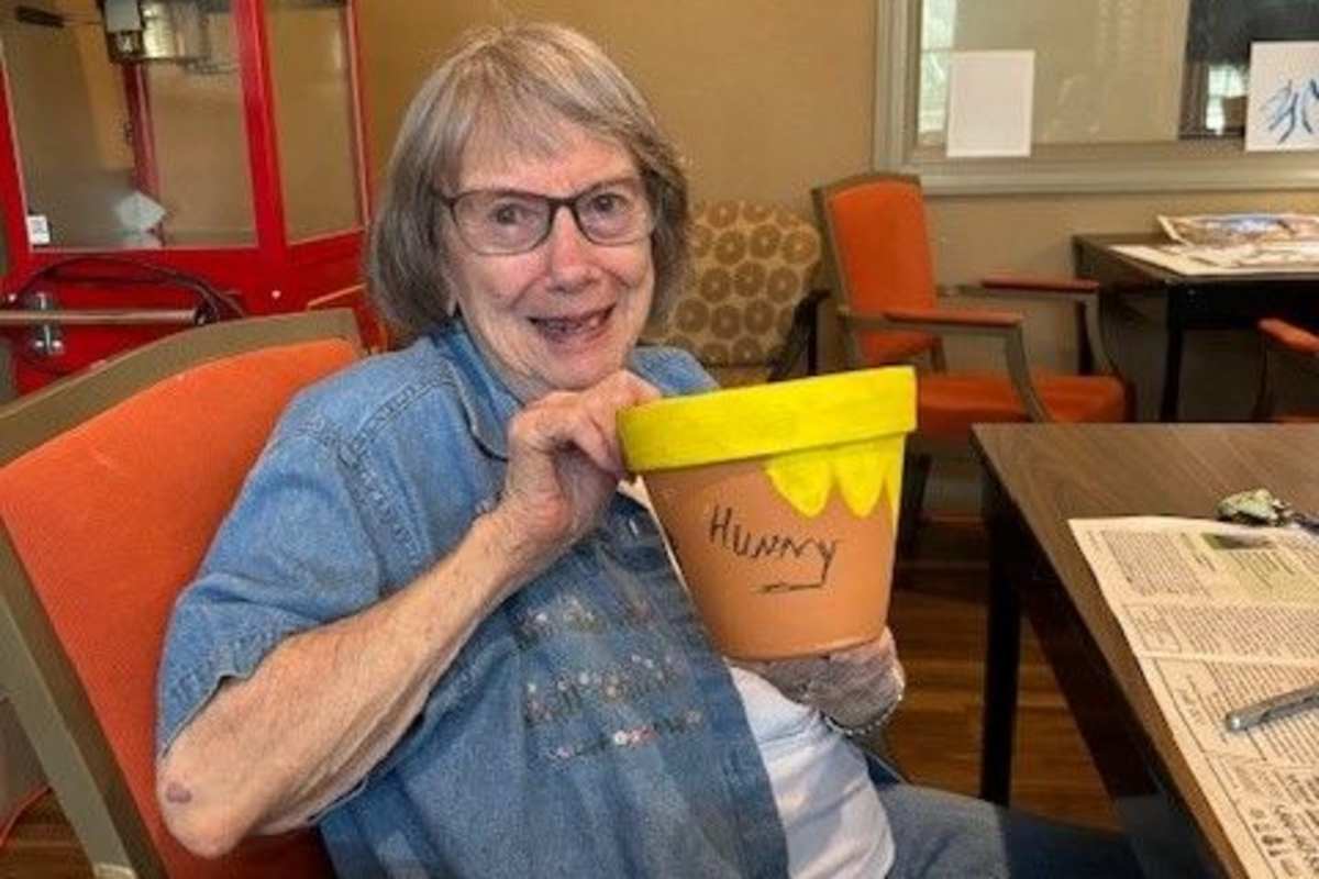 Resident showing off a craft she made at Watercrest at Kingwood in Kingwood, Texas