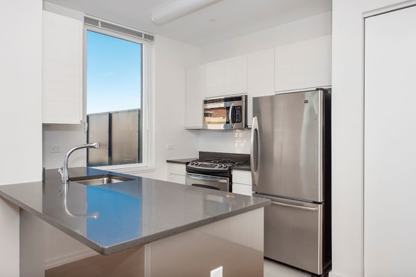 Stainless steel appliances in the modern kitchen at The Maximilian in Queens, New York